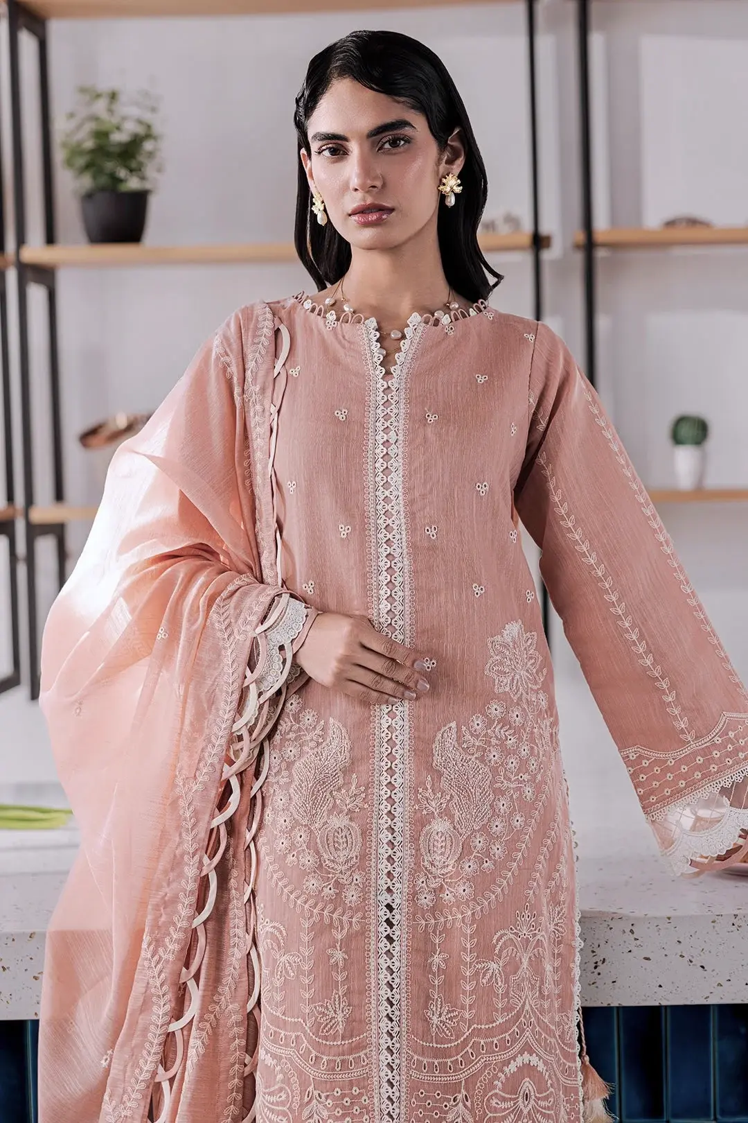 Model in a blush pink embroidered lawn suit with a matching dupatta